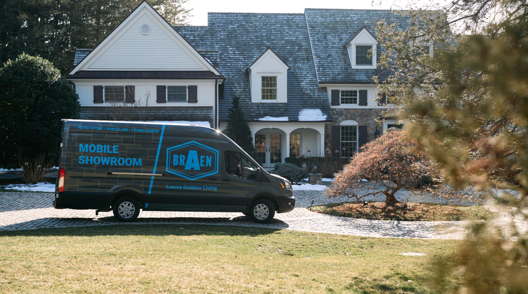 Mobile showroom for stone parked in front of a customer's home