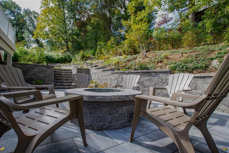 a beautiful outdoor firepit on a paver patio